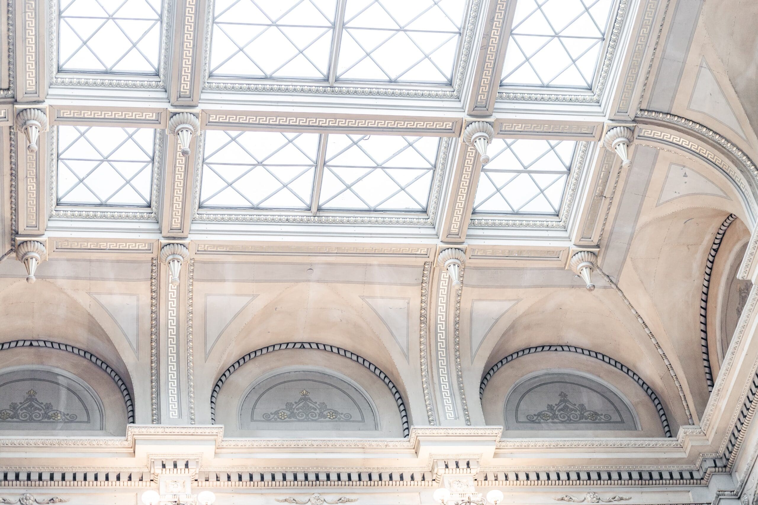 Beautiful skylight with white architecture and archway designs. Conveys a classy and timeless feel. Shot at the George Peabody Library in Baltimore.